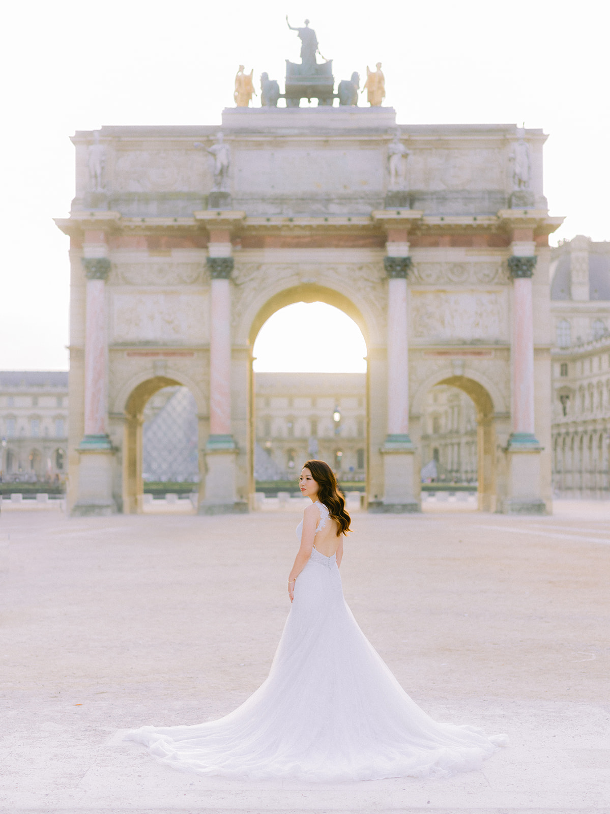 Bride posing in front of an arch 